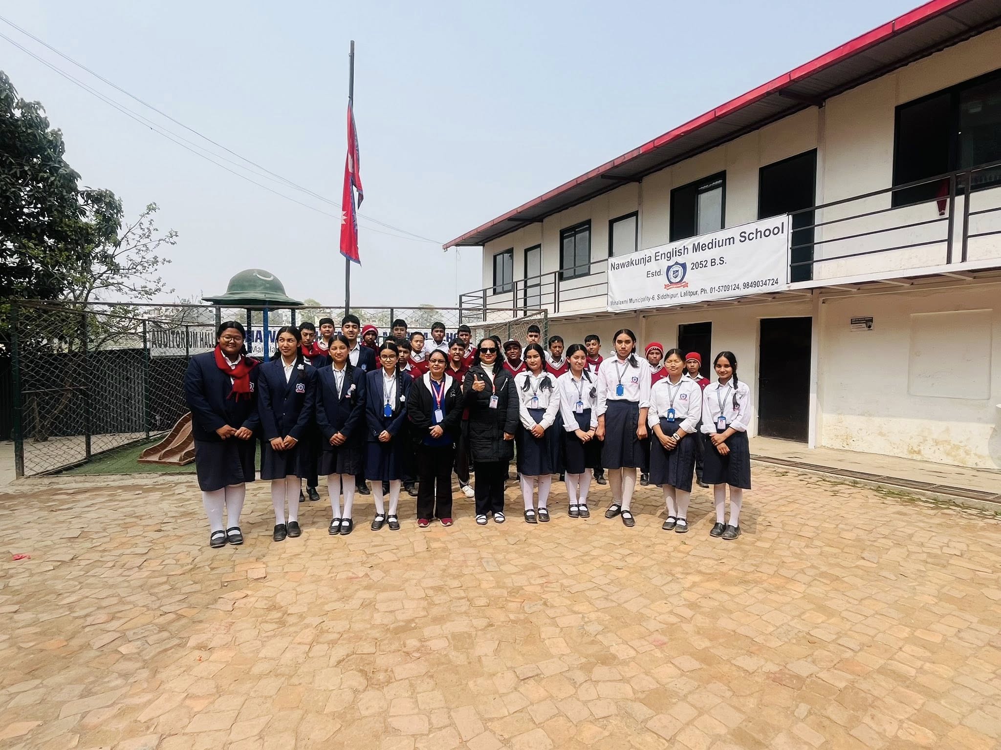 Nawakunja students and teachers group photograph in front of the school building